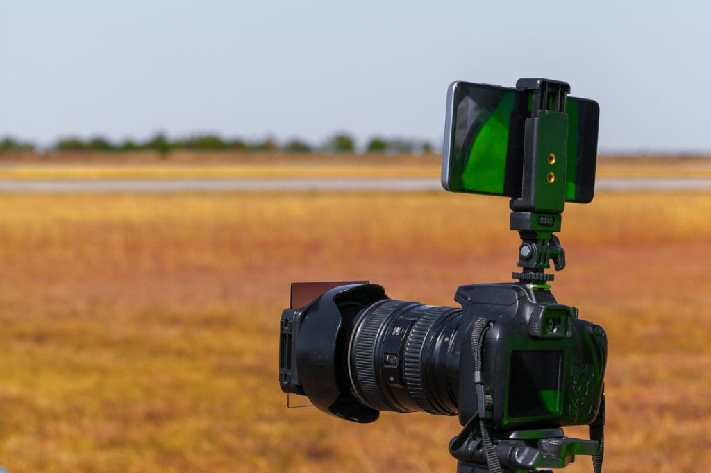 Modern camera on a tripod in the field