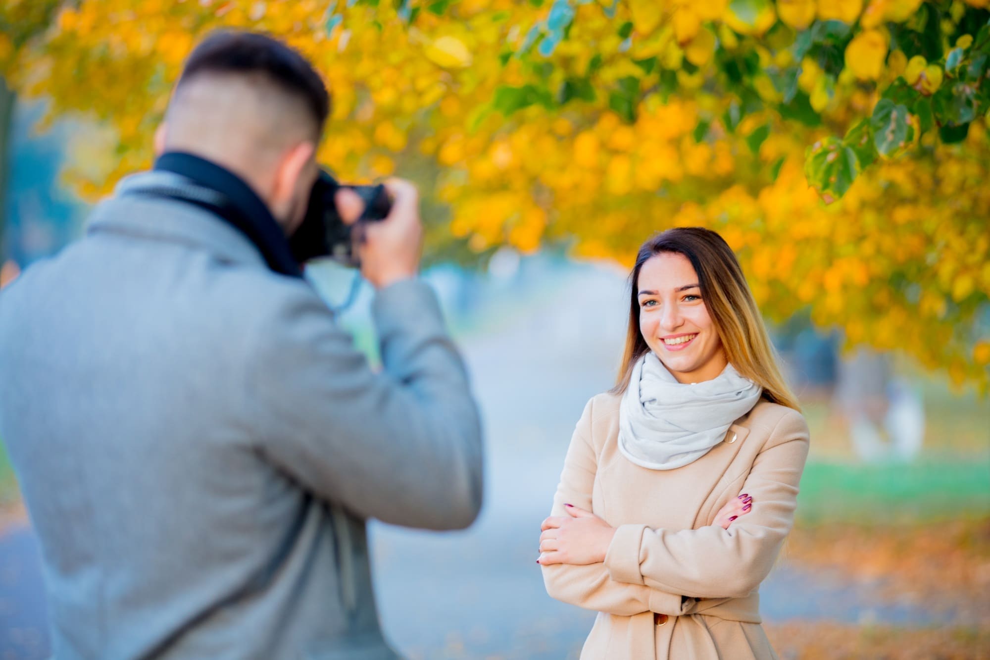 Young photographer with camera and model