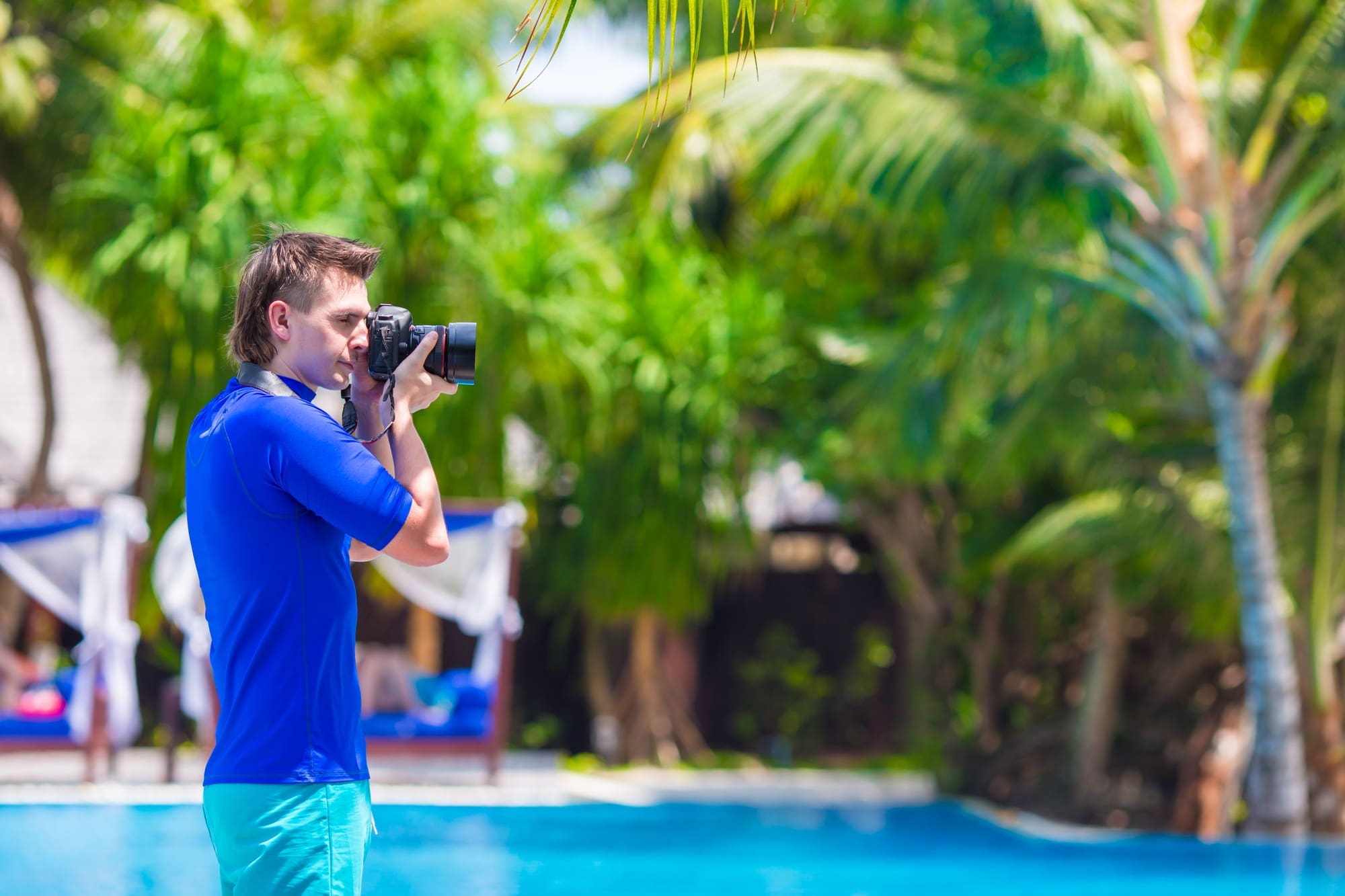 Young man photographing landscape on a tropical island